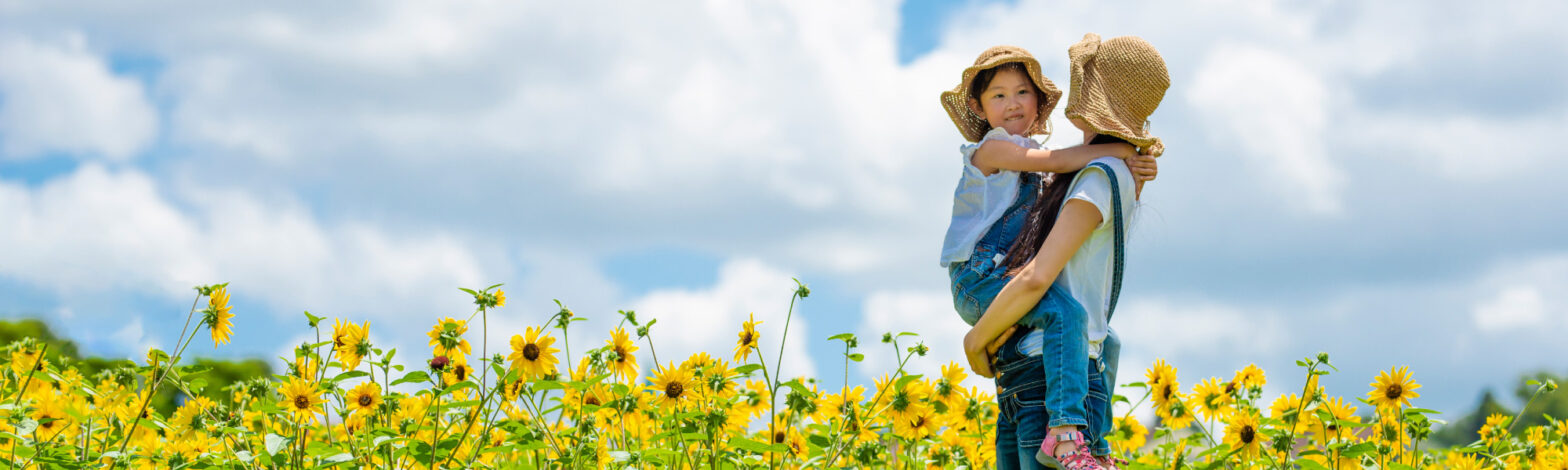 Earth Day parent and child in sunflower field
