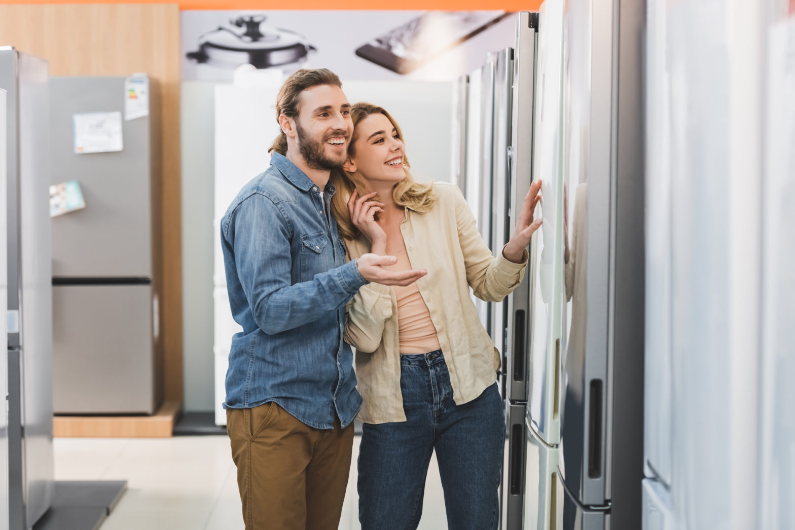 Couple looking at refrigerators in a store