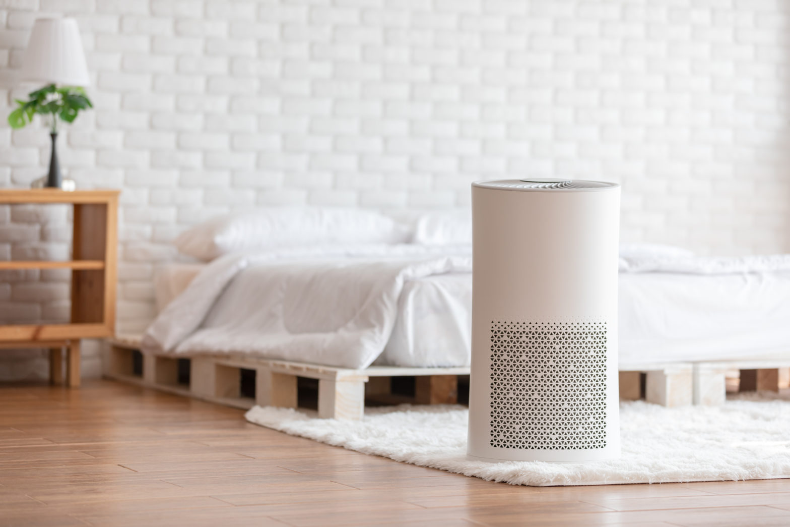 Large air purifier in modern white bedroom