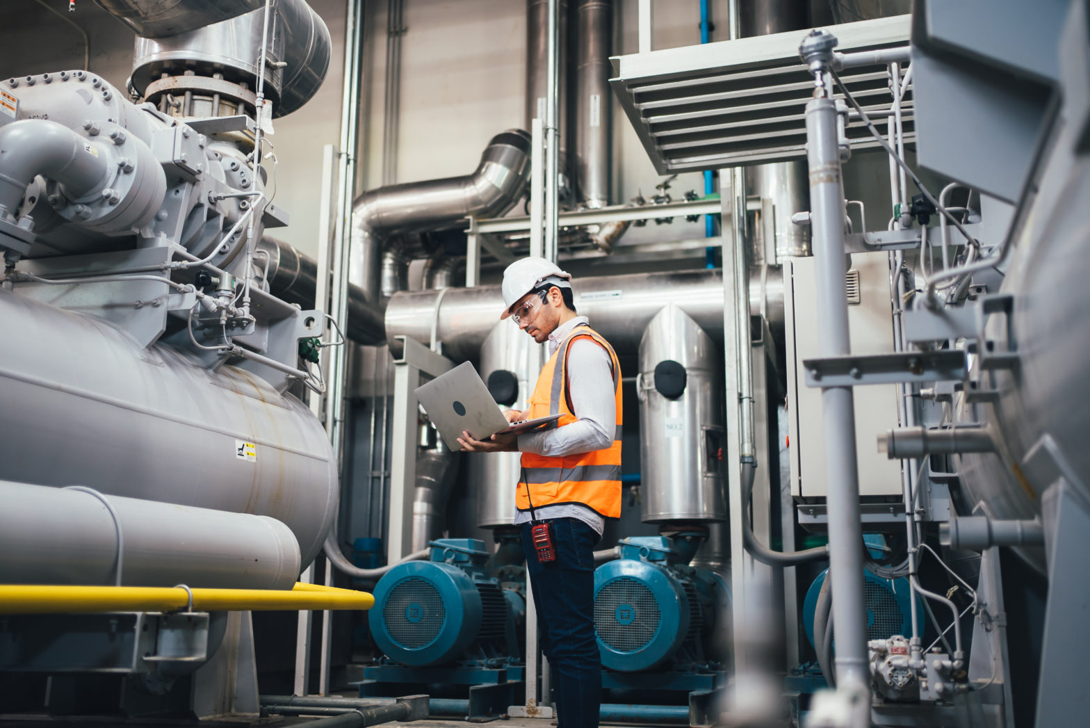 Man with laptop in industrial building