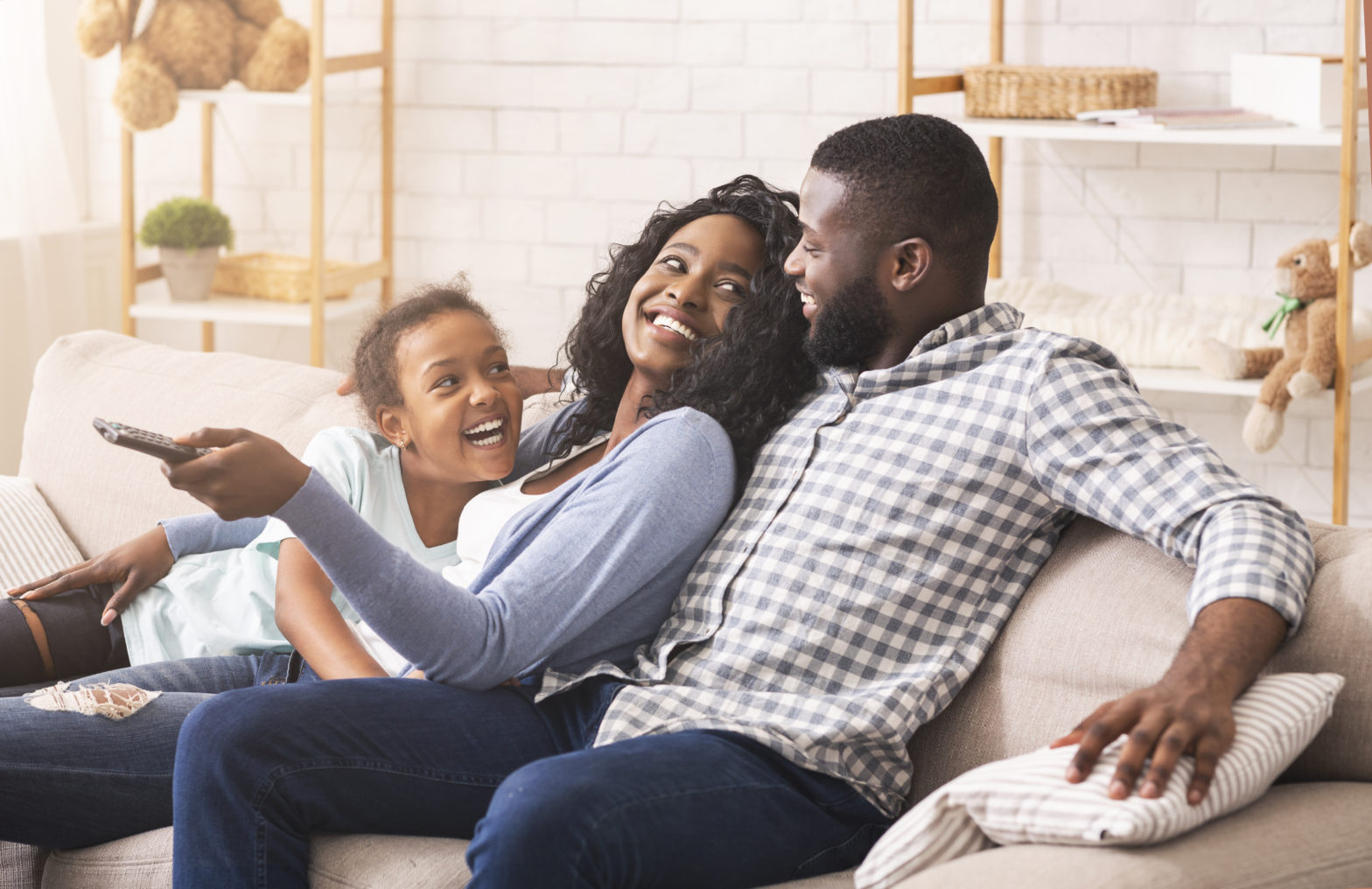 Family on couch with remote control